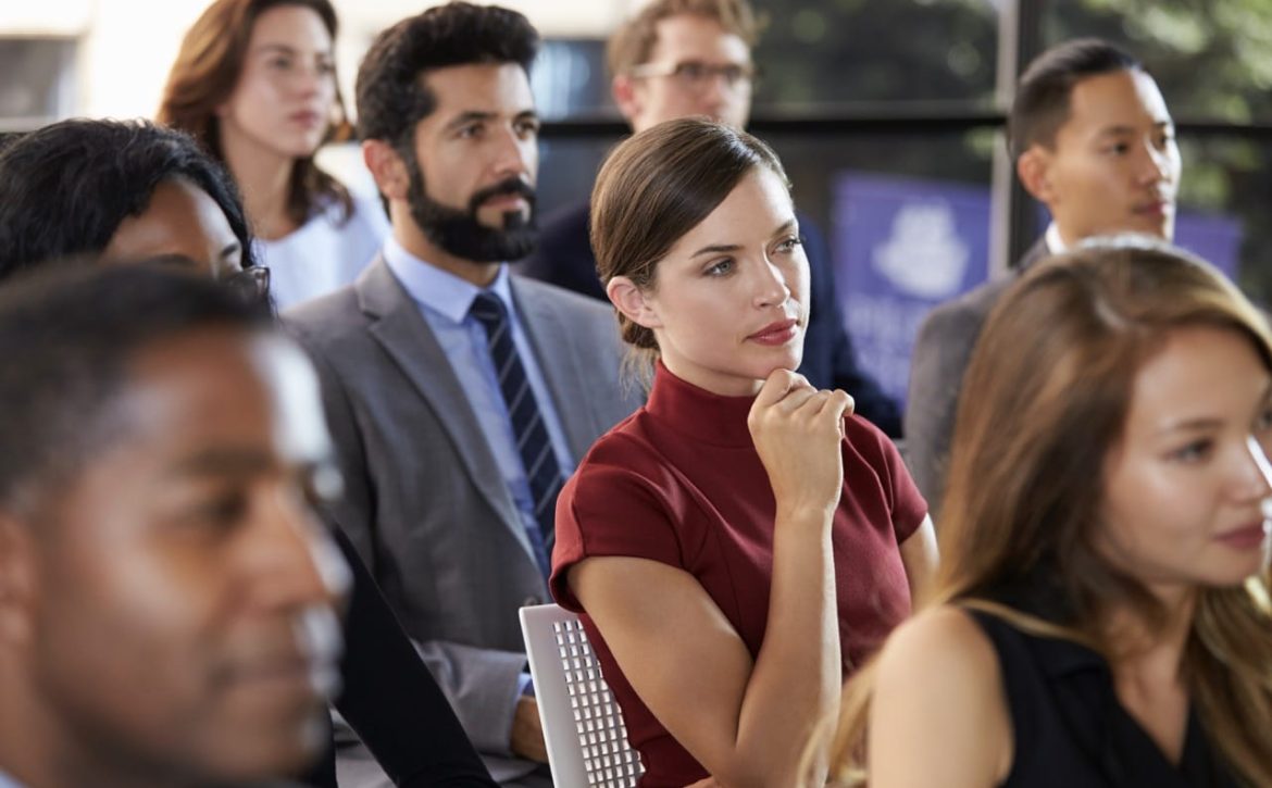 Audience at a business seminar listening to a speaker